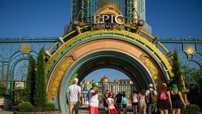 Guests arrive at the entrance portal to the Epic Universe theme park in Orlando, Florida, US, on Saturday, April 5, 2025. Photographer: Thomas Simonetti/Bloomberg (Bloomberg)