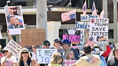 Trump's approval ratings declined as protestors held signs during a "Hands Off!" protest against the policies of the US President and his advisor, Tesla CEO Elon Musk, in Huntington Beach, California, on April 5, 2025. (Photo by Frederic J. Brown / AFP) (AFP) Trump's approval ratings declined as protestors held signs during a "Hands Off!" protest against the policies of the US President and his advisor, Tesla CEO Elon Musk, in Huntington Beach, California, on April 5, 2025. (Photo by Frederic J. Brown / AFP) (AFP)