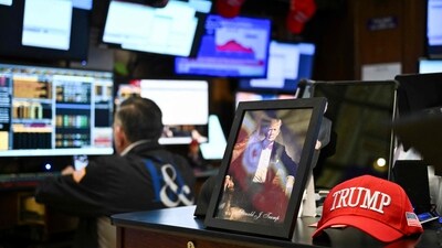 A photograph of US President Donald Trump sits on a desk as traders work on the floor of the New York Stock Exchange (NYSE) at the opening bell on April 8, 2025, in New York City. (AFP) A photograph of US President Donald Trump sits on a desk as traders work on the floor of the New York Stock Exchange (NYSE) at the opening bell on April 8, 2025, in New York City. (AFP)