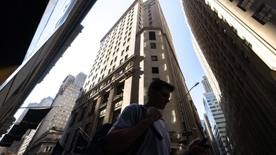 Pedestrians walk along Wall Street near the New York Stock Exchange (NYSE) in New York, US. (Bloomberg) Pedestrians walk along Wall Street near the New York Stock Exchange (NYSE) in New York, US. (Bloomberg)