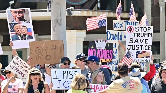 Trump's approval ratings declined as protestors held signs during a "Hands Off!" protest against the policies of the US President and his advisor, Tesla CEO Elon Musk, in Huntington Beach, California, on April 5, 2025. (Photo by Frederic J. Brown / AFP) (AFP)