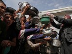 Palestinians wait to get donated food at a distribution center in Beit Lahiya in the northern Gaza Strip, Monday, April 7, 2025. Palestinians wait to get donated food at a distribution center in Beit Lahiya in the northern Gaza Strip, Monday, April 7, 2025.