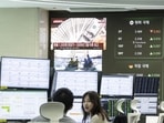 A television screen displays a news report featuring US dollar banknotes inside a trading room at Hana Bank in Seoul, South Korea, on Wednesday, April 9, 2025. 