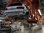 Employees work at an Audi Q5 2.0 production line of the German car manufacturer's plant during a media tour in San Jose Chiapa, Mexico. 