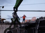 A man wearing vest and helmet gestures while using a cellphone during the recovery efforts at the site of the collapsed Jet Set nightclub in Santo Domingo, Dominican Republic, April 9, 2025.