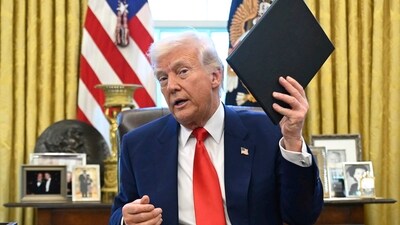 President Donald Trump holds an executive order in the Oval Office of the White House. AP/PTI(AP04_10_2025_000017B) (AP) President Donald Trump holds an executive order in the Oval Office of the White House. AP/PTI(AP04_10_2025_000017B) (AP)