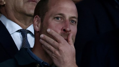 Britain's Prince William, Prince of Wales (top) areacts in the stands during the UEFA Champions League Quarter final first leg football match between Paris Saint-Germain (FRA) and Aston Villa (ENG) at the Parc des Princes stadium in Paris on April 9, 2025. (Photo by Thibaud MORITZ / AFP) (AFP)