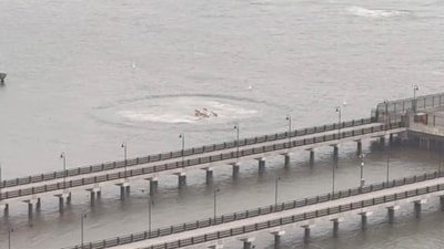 A view shows the scene of a helicopter crash on the Hudson River near lower Manhattan, as seen from Jersey City, (Ryan Card via REUTERS)