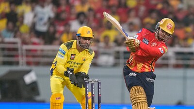 MS Dhoni (L) looks on as Priyansh Arya deposits one into the stands (PTI)