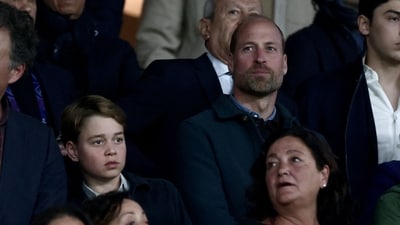 TOPSHOT - Britain's Prince William, Prince of Wales (CR) and his son Britain's Prince George of Wales (CL) look on from the stands ahead of the UEFA Champions League Quarter final first leg football match between Paris Saint-Germain (FRA) and Aston Villa (ENG) at the Parc des Princes stadium in Paris on April 9, 2025. (Photo by Thibaud MORITZ / AFP) (AFP)