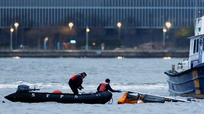 Emergency personnel work at the scene of a helicopter crash on the Hudson River near lower Manhattan in New York, as seen from Newport, New Jersey U.S., April 10, 2025. (Reuters)