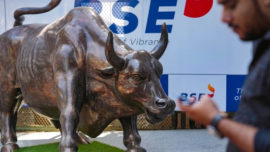 Stock market holiday today: A man walks past the bull statue at BSE building in Mumbai. (PTI)