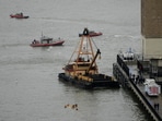 A crane vessel arrives at the scene where a helicopter crashed into the Hudson River, Thursday, April 10, 2025, in Jersey City, N.J. (AP Photo/Seth Wenig)