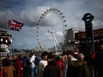 Pedestrians walk along Embankment backdropped by The London Eye, in London, on February 25, 2025. Pedestrians walk along Embankment backdropped by The London Eye, in London, on February 25, 2025.
