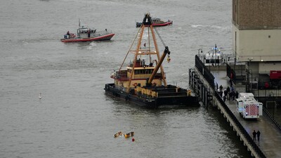 A crane vessel arrives at the scene where a helicopter crashed into the Hudson River, Thursday, April 10, 2025, in Jersey City, N.J. (AP Photo/Seth Wenig) (AP) A crane vessel arrives at the scene where a helicopter crashed into the Hudson River, Thursday, April 10, 2025, in Jersey City, N.J. (AP Photo/Seth Wenig) (AP)