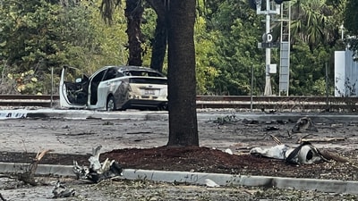 Emergency personnel respond to the area where a small plane crashed on the railroad tracks beneath the overpass near Interstate 95 in Boca Raton (AP)
