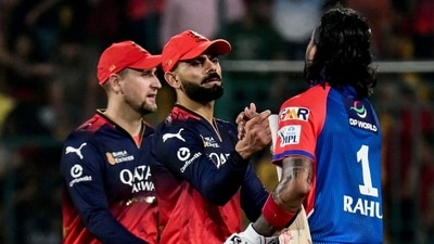 Delhi Capitals' KL Rahul (R) is congratulated by Royal Challengers Bengaluru's Virat Kohli (C) for his innings at the end of the Indian Premier League (IPL) Twenty20 cricket match (AFP)