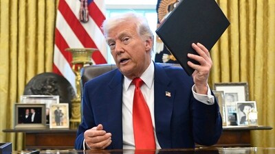 President Donald Trump holds an executive order in the Oval Office of the White House Wednesday, April 9, 2025, in Washington. (AP)