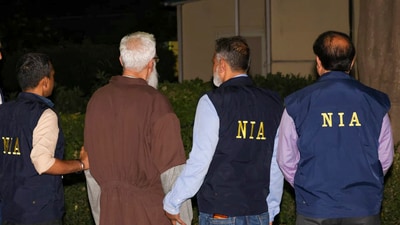 Mumbai terror attack accused Tahawwur Hussain Rana with NIA officials upon his arrival at the IGI Airport, in New Delhi. (PTI Photo) Mumbai terror attack accused Tahawwur Hussain Rana with NIA officials upon his arrival at the IGI Airport, in New Delhi. (PTI Photo)
