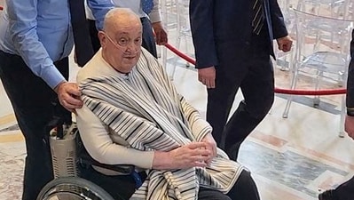 Pope Francis makes a surprise visit to St. Peter's Basilica not dressed in his usual white papal attire (via REUTERS)