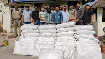 The police with the arrested individuals and the cannabis consignment. (Sourced photo) The police with the arrested individuals and the cannabis consignment. (Sourced photo)