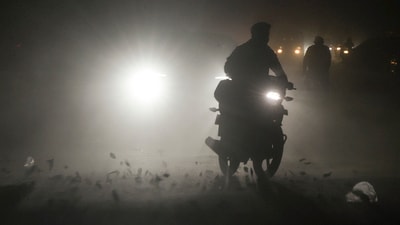 Commuters move through a dust storm, in Ghaziabad, Uttar Pradesh, near Delhi, on Friday (PTI)
