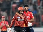 Sunrisers Hyderabad's Abhishek Sharma (L) is congratulated by Punjab Kings' Arshdeep Singh