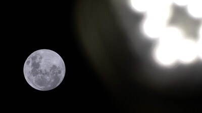 A streetlight glows as the full moon rises over Kiama Surf Beach, about 120 kilometres south of Sydney, on April 12, 2025. (AFP) A streetlight glows as the full moon rises over Kiama Surf Beach, about 120 kilometres south of Sydney, on April 12, 2025. (AFP)