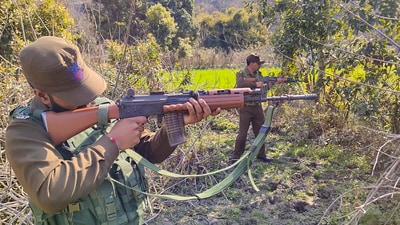 Security personnel during a search operation near LoC forest area, in Akhnoor sector in Jammu. (PTI)
