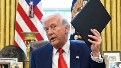 President Donald Trump holds an executive order in the Oval Office of the White House, in Washington. (AP File) President Donald Trump holds an executive order in the Oval Office of the White House, in Washington. (AP File)