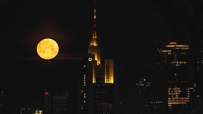 The spring's first full moon, also known as "Pink Moon", is seen behind the headquarters of Commerzbank bank (C) in the banking district of Frankfurt am Main, western Germany on April 12, 2025. (AFP) The spring's first full moon, also known as "Pink Moon", is seen behind the headquarters of Commerzbank bank (C) in the banking district of Frankfurt am Main, western Germany on April 12, 2025. (AFP)