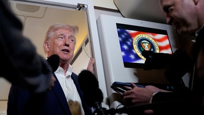 U.S. President Donald Trump talks to the media on board Air Force One on the way to Palm Beach International Airport (REUTERS)