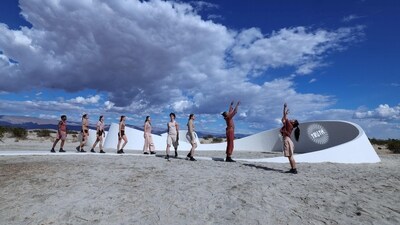 Dancers perform in front of French-American artist Sarah Meyohas' piece beaming the words "Truth Arrives in Slanted Beams" across the sides of a meandering wall. (Photo by VALERIE MACON / AFP) (AFP) Dancers perform in front of French-American artist Sarah Meyohas' piece beaming the words "Truth Arrives in Slanted Beams" across the sides of a meandering wall. (Photo by VALERIE MACON / AFP) (AFP)