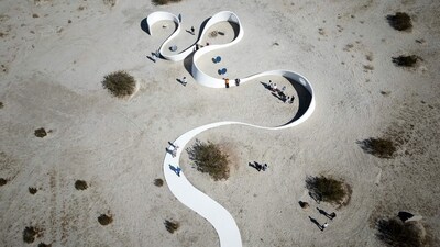 Aerial view of French-American artist Sarah Meyohas' piece "Truth Arrives in Slanted Beams," which uses curved metallic mirrors to reflect and refract sunlight, beaming the words across the sides of a meandering wall during the media preview day of the Desert X exhibit, in the Coachella Valley near Desert Hot Springs, California, on March 7, 2025. (Photo by Valerie MACON / AFP) (AFP) Aerial view of French-American artist Sarah Meyohas' piece "Truth Arrives in Slanted Beams," which uses curved metallic mirrors to reflect and refract sunlight, beaming the words across the sides of a meandering wall during the media preview day of the Desert X exhibit, in the Coachella Valley near Desert Hot Springs, California, on March 7, 2025. (Photo by Valerie MACON / AFP) (AFP)