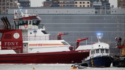 First responders (R) were spotted close to the aircraft's landing skids (foreground, in water). (Photo by Leonardo Munoz / AFP) (AFP) First responders (R) were spotted close to the aircraft's landing skids (foreground, in water). (Photo by Leonardo Munoz / AFP) (AFP)