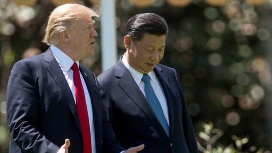 US President Donald Trump (L) and Chinese President Xi Jinping (R) walk together at the Mar-a-Lago estate in Palm Beach, Florida. (AFP File)