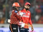 Sunrisers Hyderabad's Abhishek Sharma (L) is congratulated by Punjab Kings' captain Shreyas Iyer for his innings as he walks back to the pavilion after his dismissal