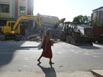 A Buddhist monk walks past the debris of a damaged pagoda in Mandalay on April 13, 2025, following the devastating earthquake in Myanmar.