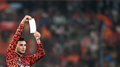 Sunrisers Hyderabad's Abhishek Sharma holds a paper reading "This one's for the Orange Army" as he celebrates after scoring a century against Punjab Kings. (AFP) Sunrisers Hyderabad's Abhishek Sharma holds a paper reading "This one's for the Orange Army" as he celebrates after scoring a century against Punjab Kings. (AFP)