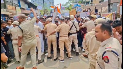 Police personnel stop protestors during a demonstration against Waqf Act in Assam’s Silchar on Sunday. (PTI) Police personnel stop protestors during a demonstration against Waqf Act in Assam’s Silchar on Sunday. (PTI)