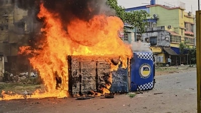Smoke and flames billow out from a vehicle after it was set ablaze during a protest over the Waqf (Amendment) Act in Murshidabad district of West Bengal on Tuesday (PTI) Smoke and flames billow out from a vehicle after it was set ablaze during a protest over the Waqf (Amendment) Act in Murshidabad district of West Bengal on Tuesday (PTI)