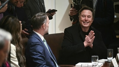 Elon Musk (R) attends cabinet meeting with US President Donald Trump in the Cabinet Room of the White House on April 10, 2025, in Washington, DC. Trump on Thursday warned of the "transition cost" from his tariff policies, as Wall Street stocks fell again over the worsening trade war with China. (Photo by Brendan SMIALOWSKI / AFP) (AFP) Elon Musk (R) attends cabinet meeting with US President Donald Trump in the Cabinet Room of the White House on April 10, 2025, in Washington, DC. Trump on Thursday warned of the "transition cost" from his tariff policies, as Wall Street stocks fell again over the worsening trade war with China. (Photo by Brendan SMIALOWSKI / AFP) (AFP)