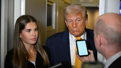 Trump (C) listens to reporters as his granddaughter Kai Madison Trump looks on on board Air Force One while flying from Miami to Palm Beach on April 13, 2025, after watching the featherweight fight between Australian fighter Alexander Volkanovski and Brazilian fighter Diego Lopes (R) during UFC 314 at the Kaseya Center in Miami. (Photo by Mandel NGAN / AFP) (AFP) Trump (C) listens to reporters as his granddaughter Kai Madison Trump looks on on board Air Force One while flying from Miami to Palm Beach on April 13, 2025, after watching the featherweight fight between Australian fighter Alexander Volkanovski and Brazilian fighter Diego Lopes (R) during UFC 314 at the Kaseya Center in Miami. (Photo by Mandel NGAN / AFP) (AFP)