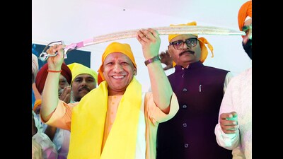 Uttar Pradesh Chief Minister Yogi Adityanath holds a sword during the Baisakhi festival celebrations, in Lucknow on Sunday. (Ravi Prakash) Uttar Pradesh Chief Minister Yogi Adityanath holds a sword during the Baisakhi festival celebrations, in Lucknow on Sunday. (Ravi Prakash)