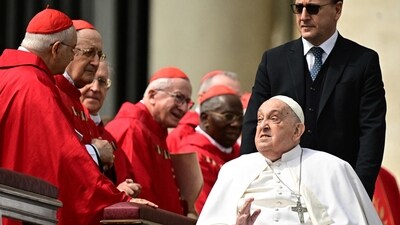 Pope Francis greets cardinals during a surprise appearance at the end of the mass for Palm Sunday at St Peter's square in the Vatican on April 13, 2025. (AFP)
