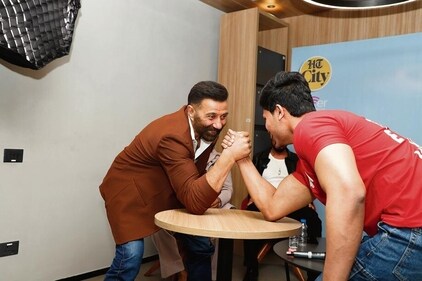 Sunny Deol in an arm wrestling battle with a fan. Sunny Deol in an arm wrestling battle with a fan.