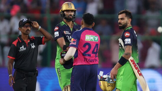 Devdutt Padikkal and Virat Kohli shake hands with the Rajasthan players after sealing the 9-wicket victory with 15 deliveries to spare.(REUTERS)