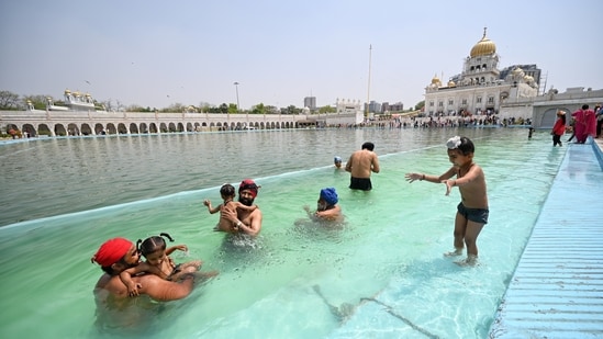 Devotees of all age groups take holy dips in the sacred sarovars in the Bangla Sahib.(HT/Sanchit Khanna)