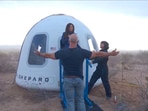 Jeff Bezos stands as Lauren Sanchez comes out of the capsule in which she, Pop star Katy Perry, journalist Gayle King, and other participants, landed back on earth after blasting off into space on a Blue Origin rocket, as part of the New Shepard Mission NS-31, marking the first all-female flight crew in more than six decades, in West Texas, Texas, U.S., April 14, 2025, in this screen grab taken from a video. Blue Origin/Handout via REUTERS 