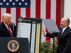 US President Donald Trump holds a chart next to US Secretary of Commerce Howard Lutnick as Trump delivers remarks on tariffs in the Rose Garden at the White House in Washington on April 2.
